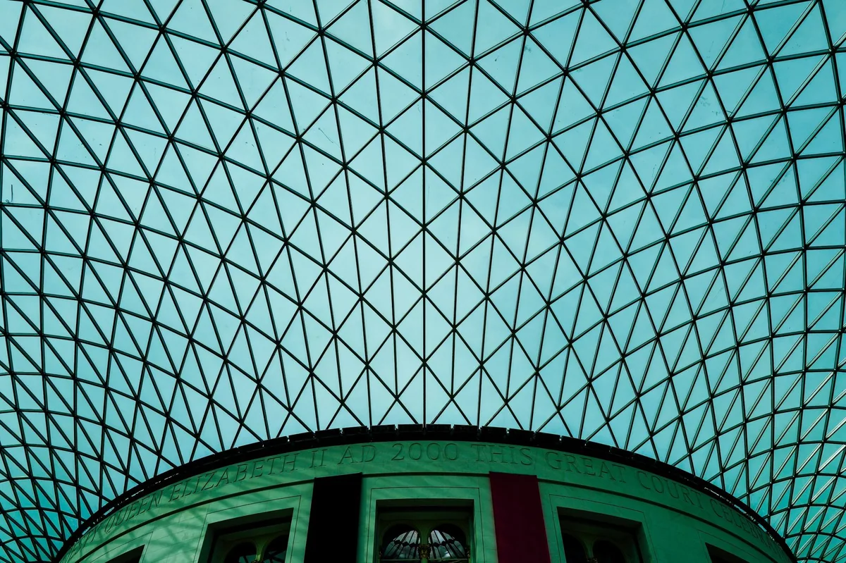 The glass and steel roof of the British Museum's Great Court curving over the round Reading Room