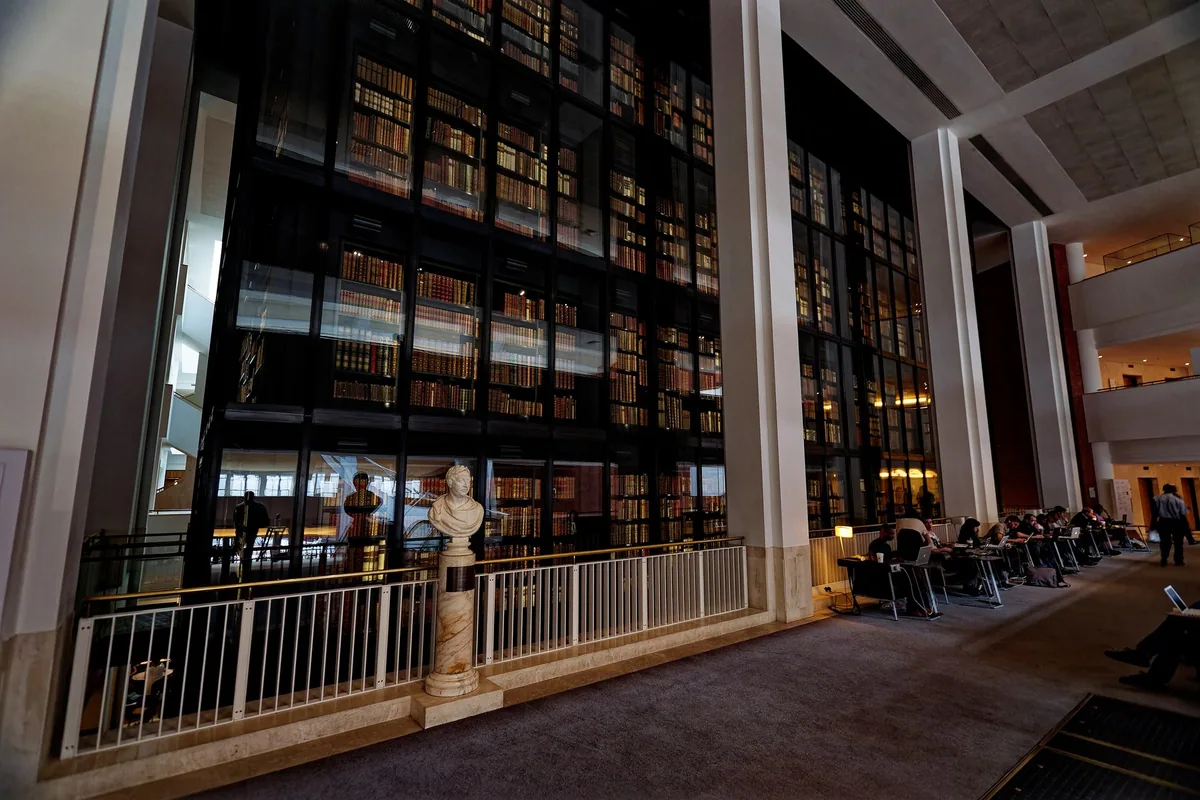 The King's Library Tower of leather-bound books behind glass inside the British Library