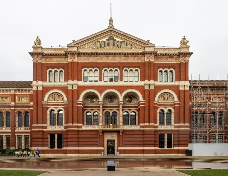 The red-brick facade and reflecting pool of the John Madejski Garden inside the Victoria and Albert Museum