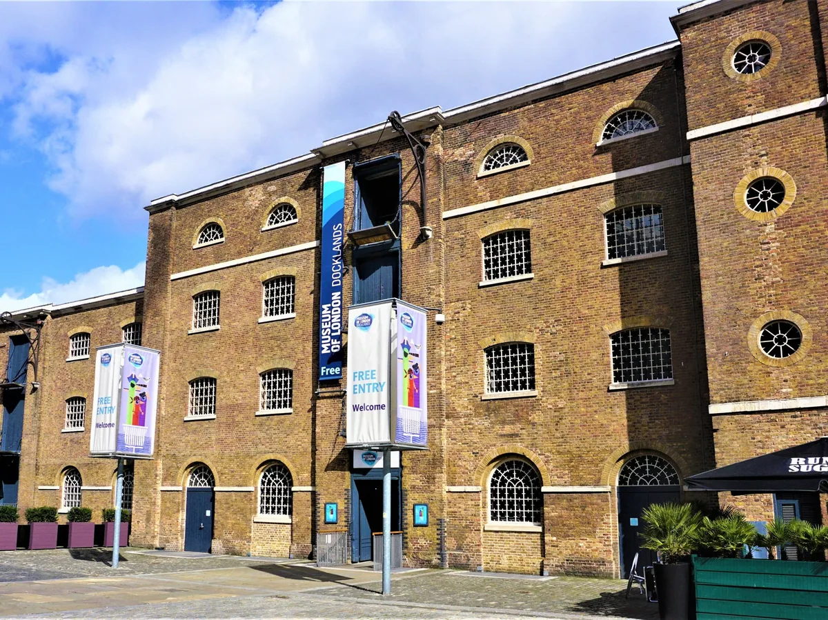 The Georgian brick warehouse at West India Quay that houses the Docklands branch of London Museum, with banners at the entrance