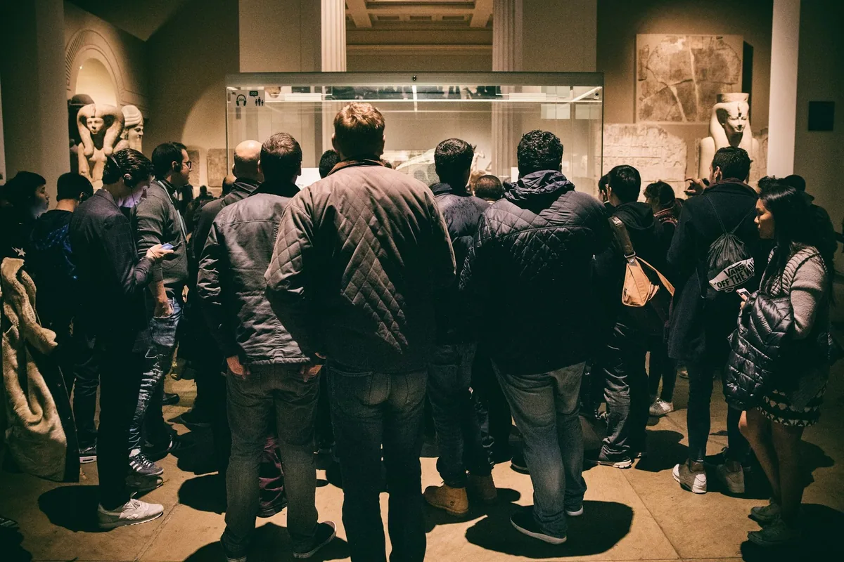 Visitors crowded around a display case in the Egyptian sculpture gallery at the British Museum