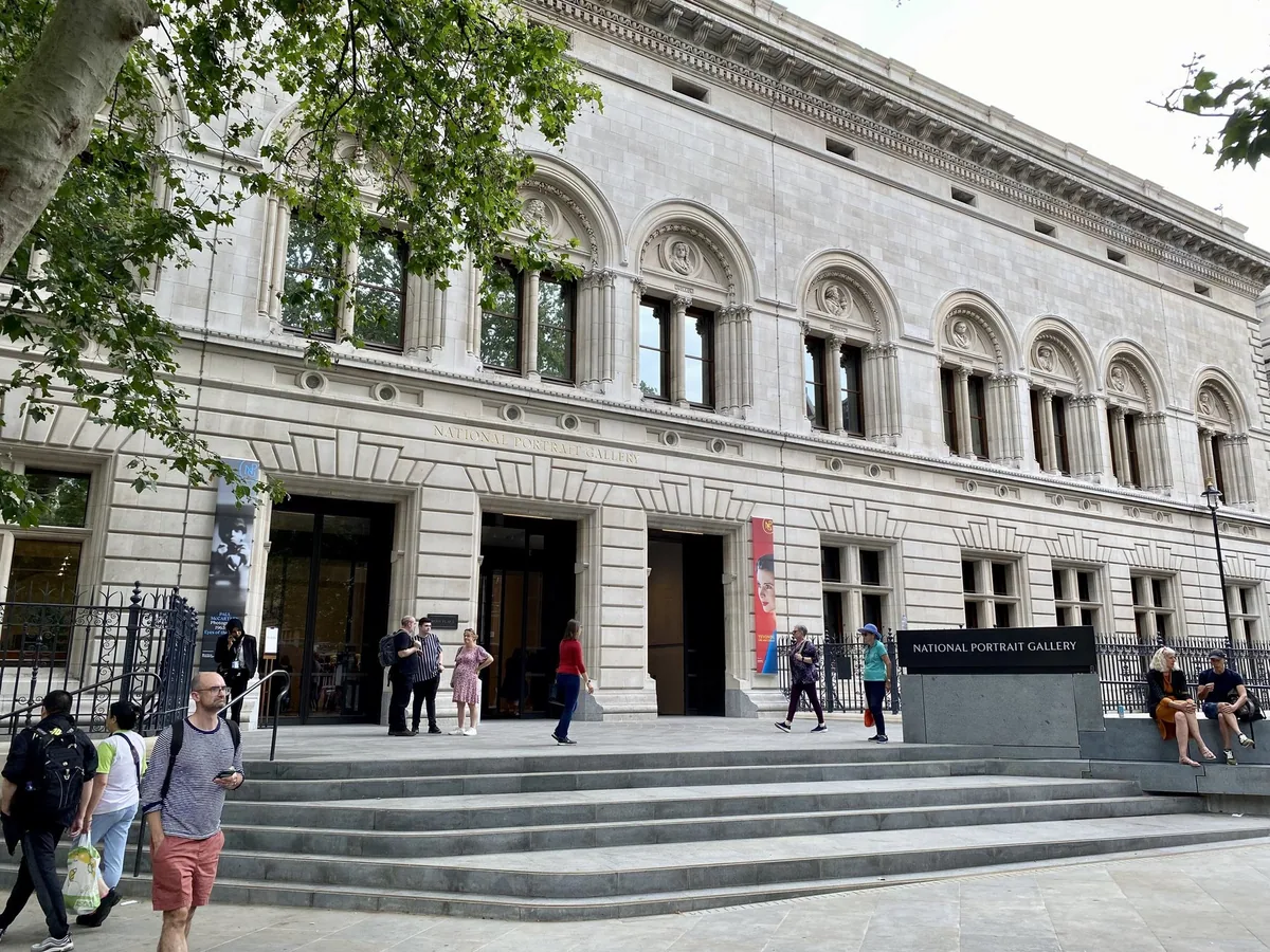 Visitors on the steps of the National Portrait Gallery's new north entrance, beneath its arched stone facade