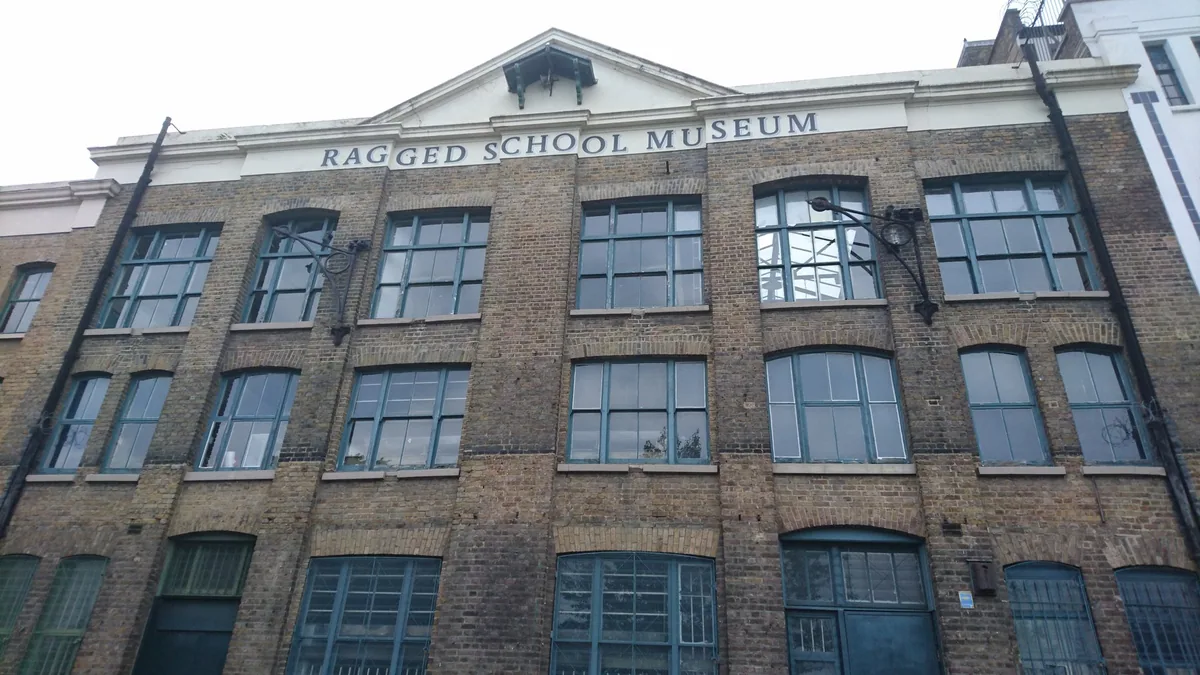 The brick canal warehouse in Mile End with Ragged School Museum lettered across its gable