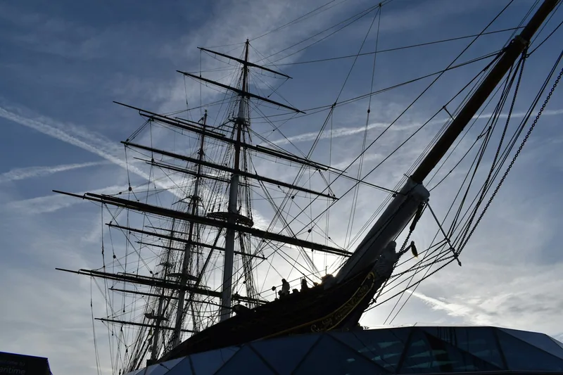 The clipper ship Cutty Sark in Greenwich seen from the bow, masts and rigging against a blue sky