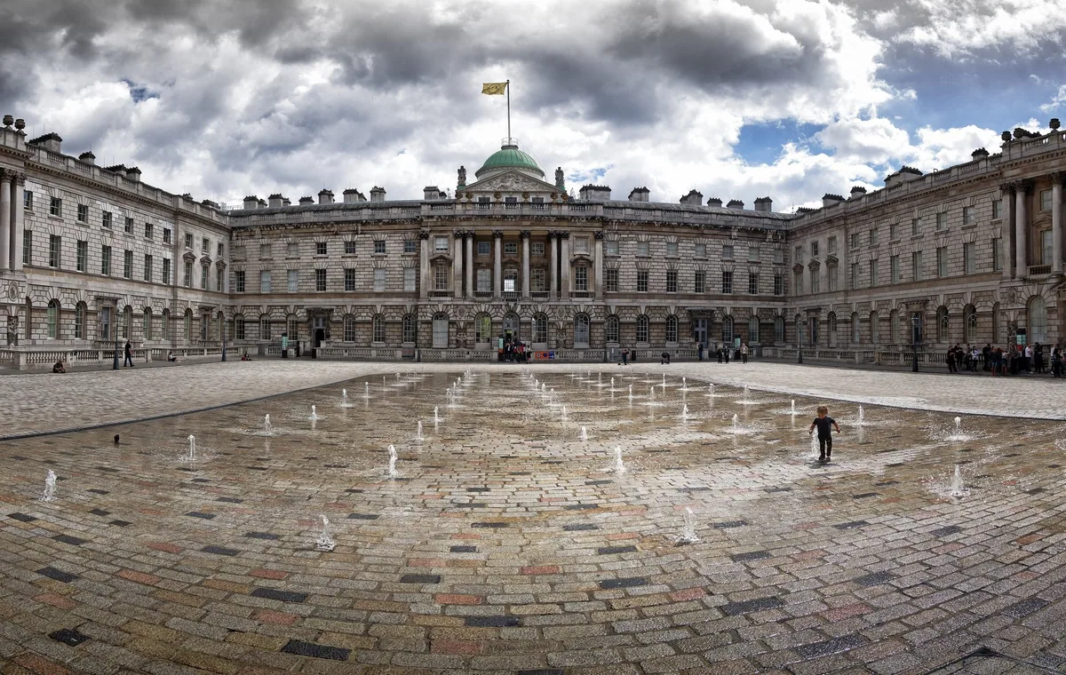 The cobbled courtyard of Somerset House with its rows of fountains playing, ringed by the neoclassical wings