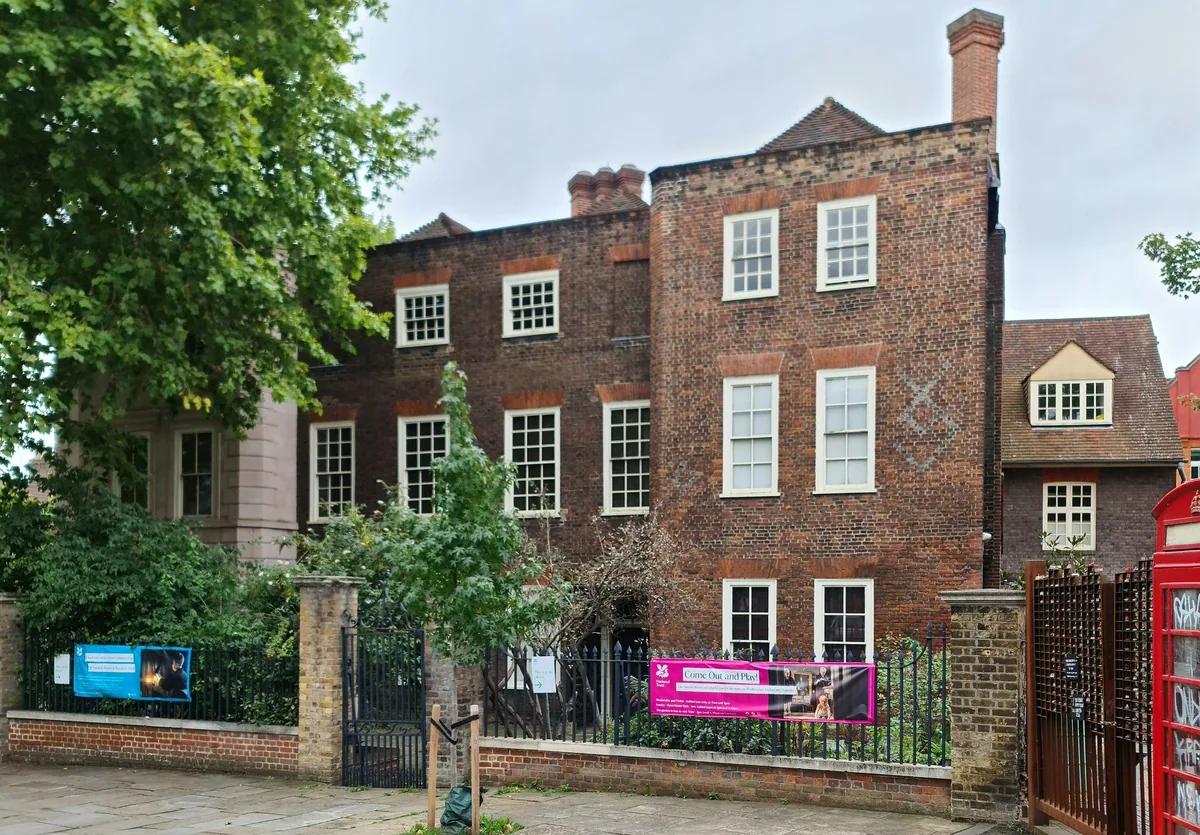 The red-brick Tudor front of Sutton House in Hackney, its diaper brickwork and white sash windows seen from the street