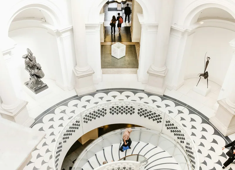 Looking down the white spiral staircase beneath the rotunda inside Tate Britain