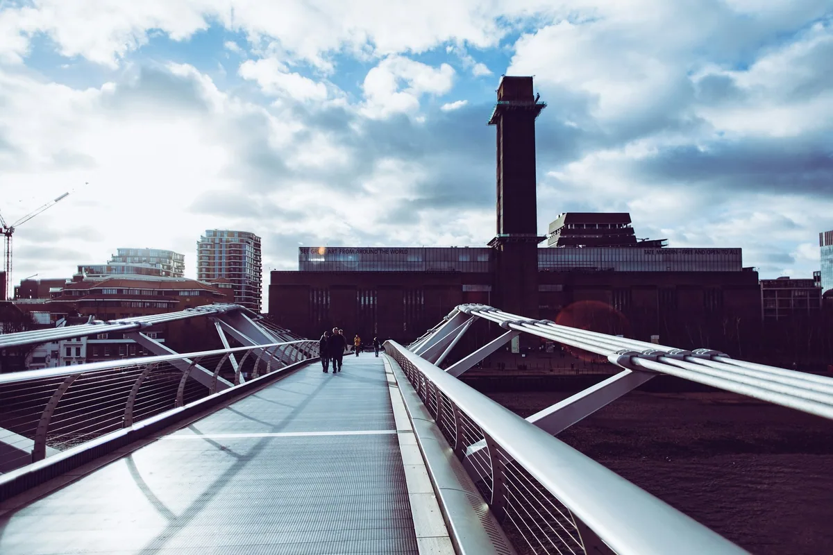 The Millennium Bridge leading across the Thames to Tate Modern's brick chimney and former power station