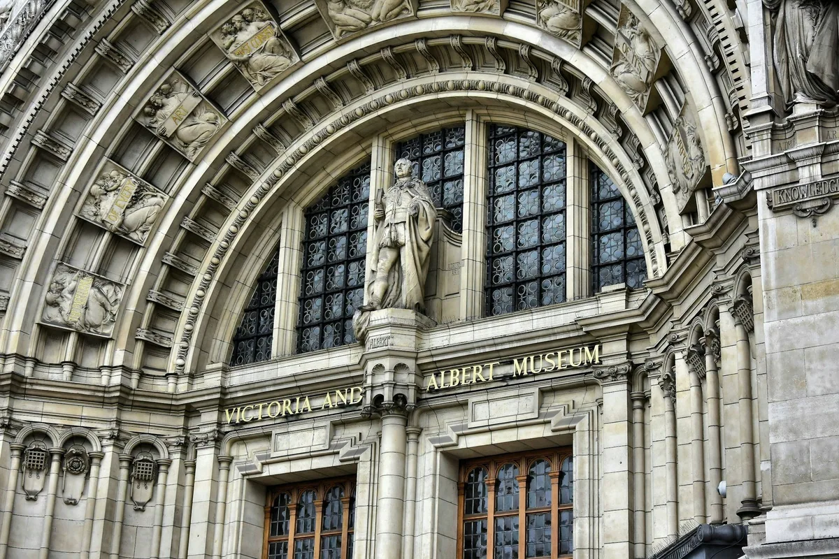 Carved stone arch over the Victoria and Albert Museum's main entrance on Cromwell Road, with the museum's name above the doors