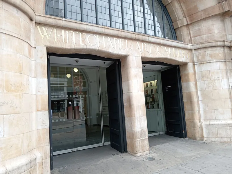 The arched stone entrance of Whitechapel Gallery with its carved name above the glass doors