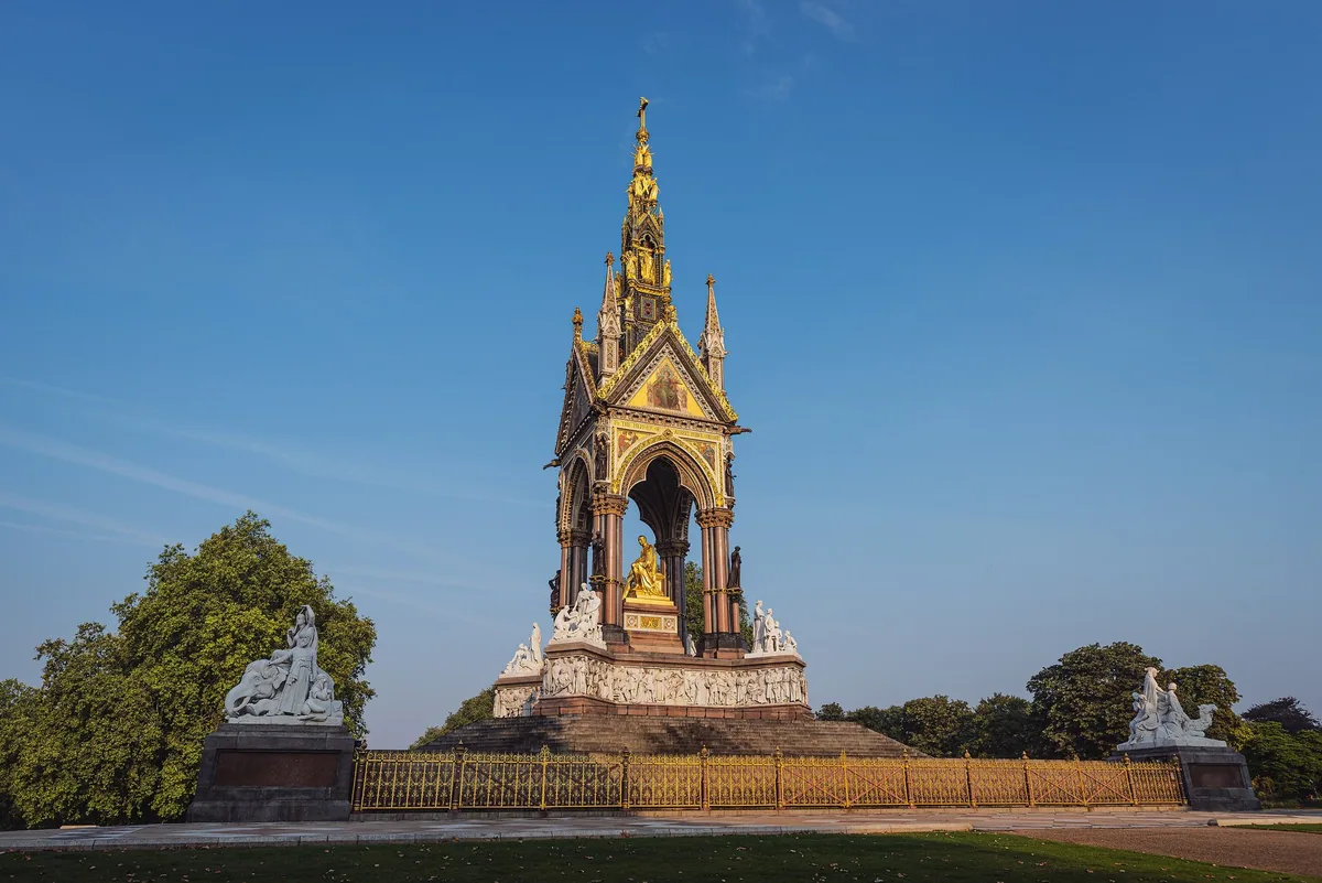 The gilded Gothic canopy of the Albert Memorial in Kensington Gardens against a clear blue sky