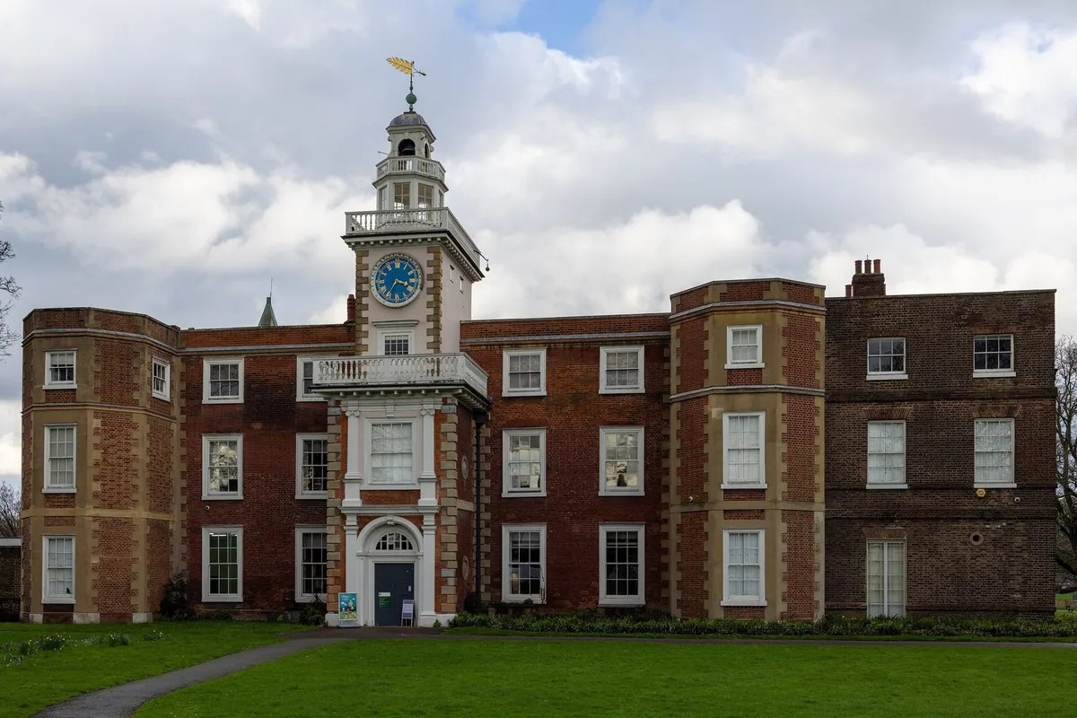 The red-brick front of Bruce Castle in Tottenham, with its white clock turret above the central porch
