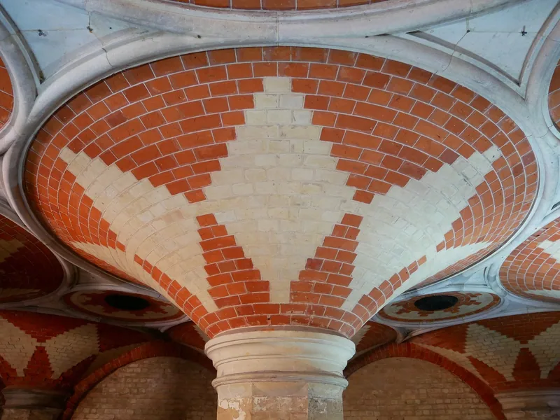 Close view of one fan vault in the Crystal Palace Subway, its red and cream brickwork spreading from a stone capital