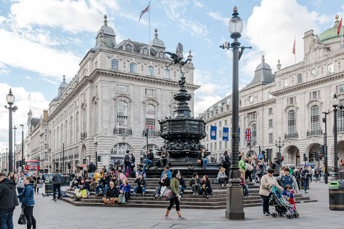 The winged bronze archer on the Shaftesbury Memorial Fountain at Piccadilly Circus, with the curved stone Quadrant facades behind