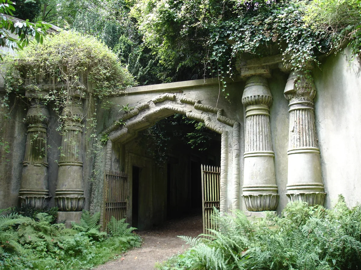 The ivy-covered Egyptian Avenue at Highgate Cemetery, its lotus columns framing a dark passage of vaults