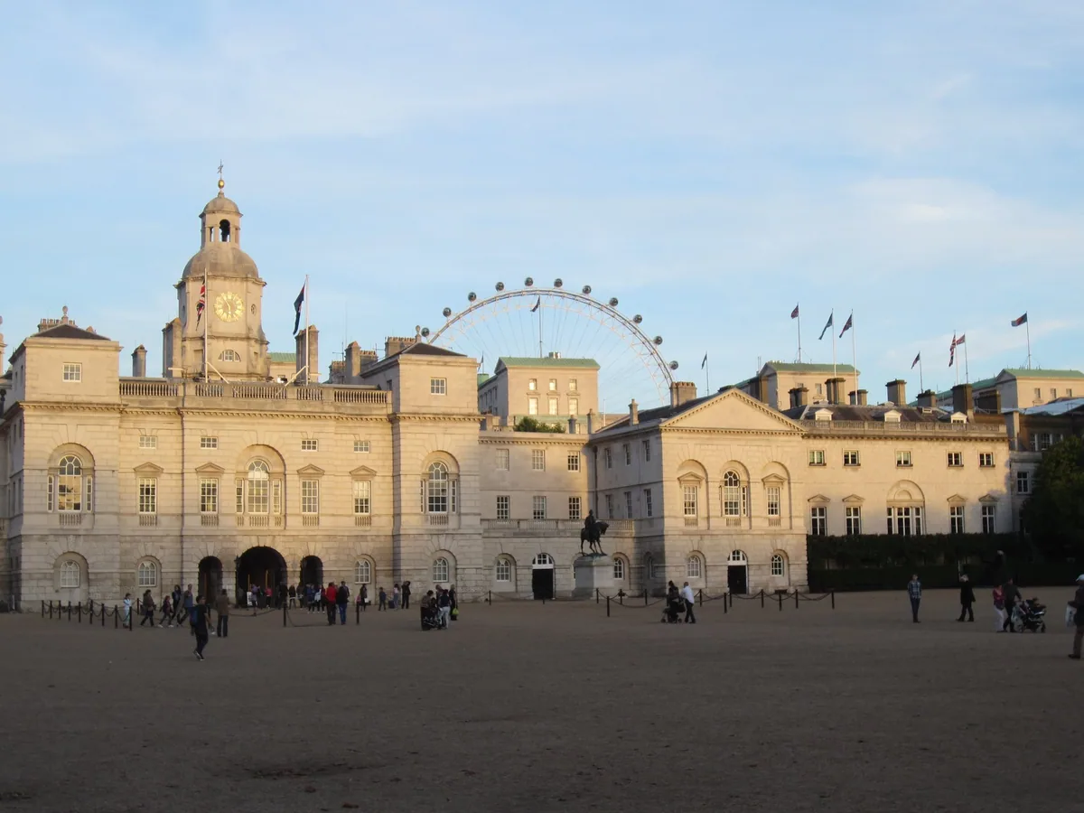 The Horse Guards building and its clock tower across the gravel of Horse Guards Parade at sunset