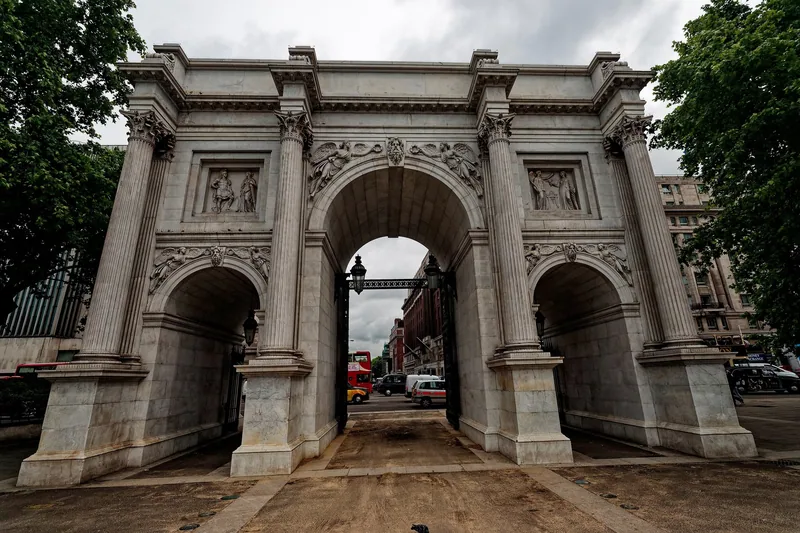 Close view through Marble Arch's central opening, with carved relief panels above the side arches