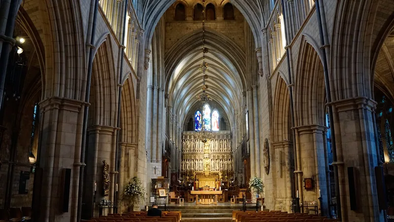 The vaulted nave of Southwark Cathedral looking east towards the carved stone altar screen