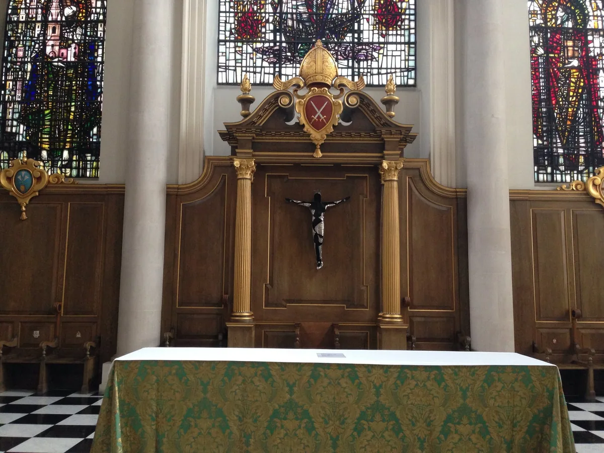 Gilded reredos and altar inside St Mary-le-Bow, with modern stained glass above