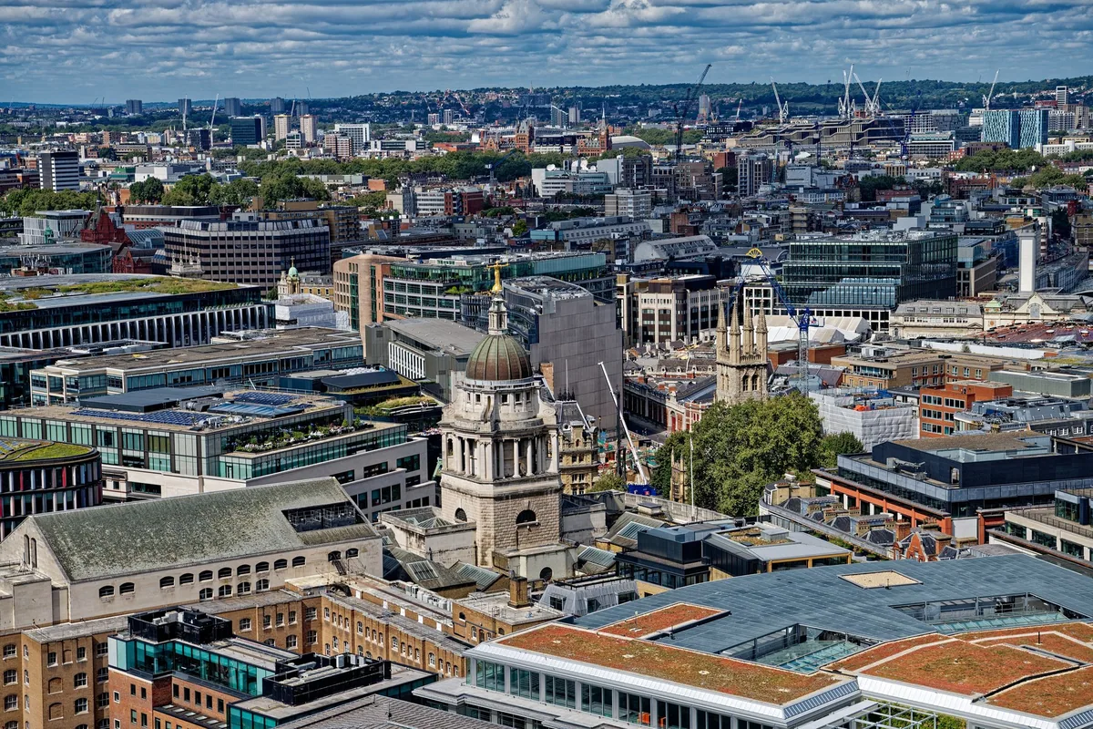 The green dome of the Old Bailey with its gilded Lady Justice statue, seen above surrounding City rooftops