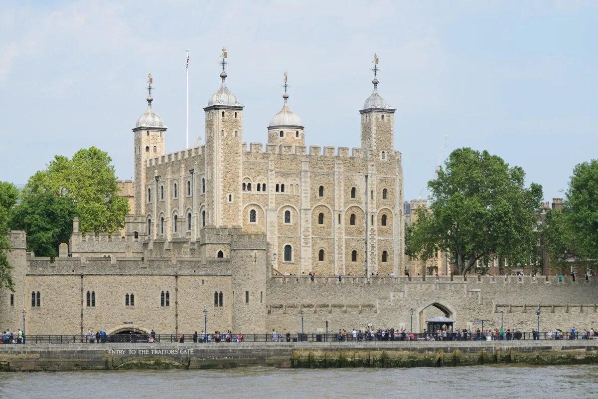 The White Tower rising above the outer wall of the Tower of London, seen across the river from the south