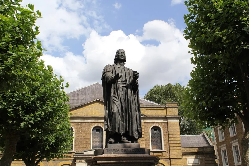 The bronze statue of John Wesley on its plinth in the chapel forecourt, with the chapel front behind