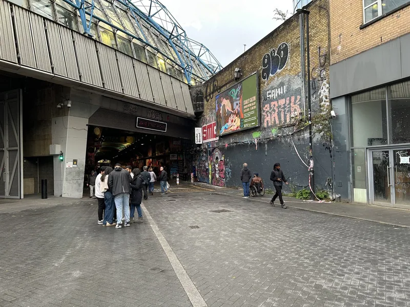 Visitors gathered at the street entrance to the Leake Street graffiti tunnel beside Waterloo station