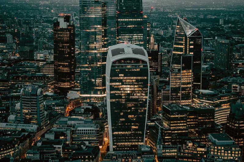 Looking down from the Shard on the lit towers of the City of London, with the Walkie-Talkie roof in the middle