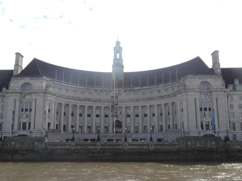 The curved central crescent of County Hall seen from the Thames, with the building's name carved above the colonnade