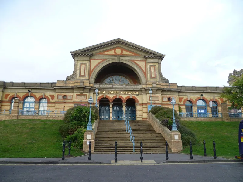The Palm Court entrance of Alexandra Palace above a wide flight of steps and grass banks