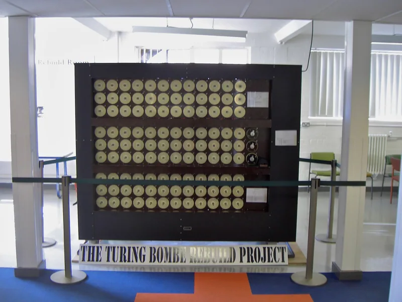 The rebuilt Turing Bombe on display at Bletchley Park, its front covered in rows of lettered rotor drums