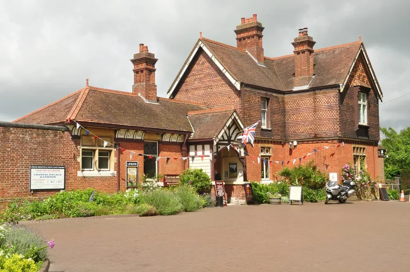 The Victorian red-brick station building at Sheffield Park on the Bluebell Railway, hung with bunting