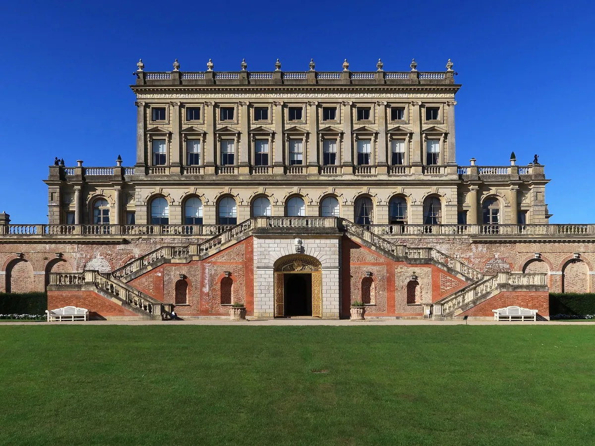 The south front of Cliveden standing on its arcaded brick terrace, with twin stone staircases curving down to the garden