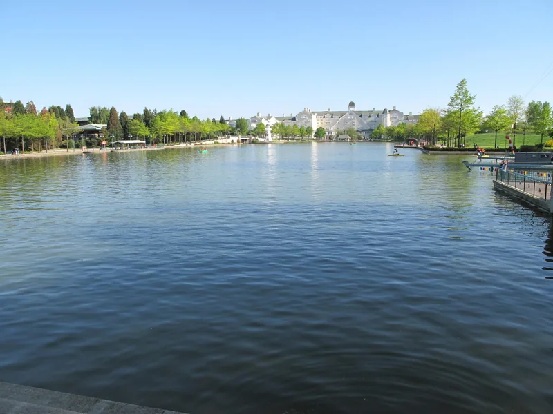 The lake at Disney Village with a large resort hotel across the water at Disneyland Paris