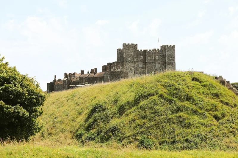 The battlemented keep of Dover Castle on its green earthwork ramparts