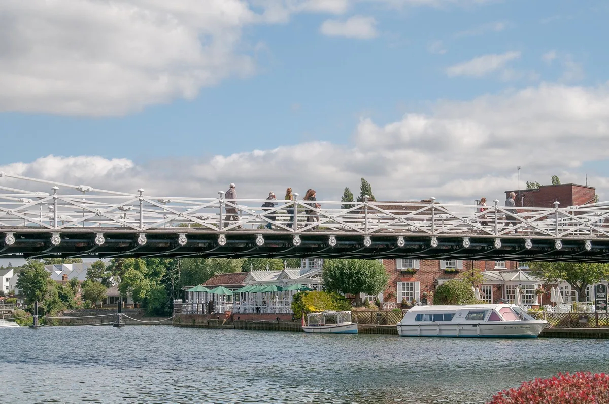 Marlow's white suspension bridge over the Thames, with moored cruisers and riverside houses behind