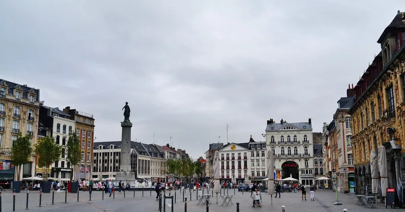 Lille's Grand Place on a grey day, the Column of the Goddess standing in the open square