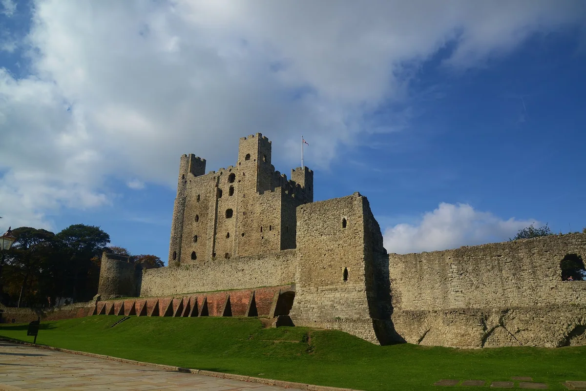 Rochester Castle's Norman keep rising above the curtain wall and the grass ditch