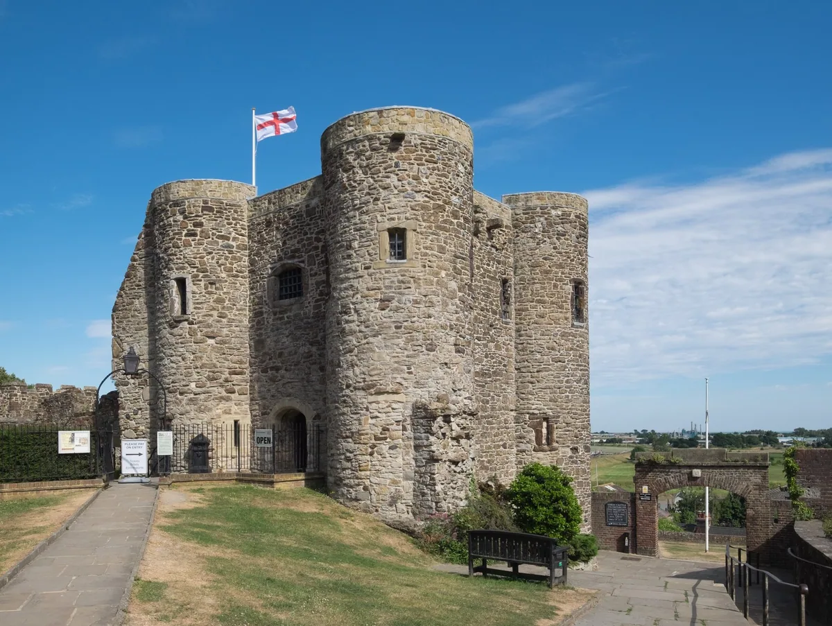 The stone Ypres Tower at Rye in East Sussex, a squat medieval tower with round corner turrets flying the St George's flag