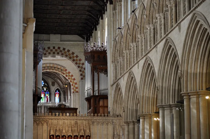 Looking along the nave of St Albans Cathedral, past the stone screen to the long row of pointed arches