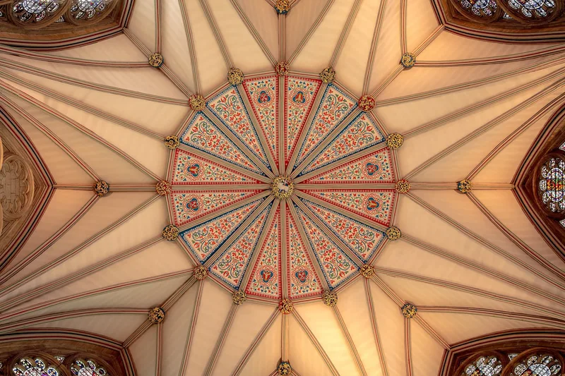 The painted vaulted ceiling of the chapter house at York Minster, seen from below