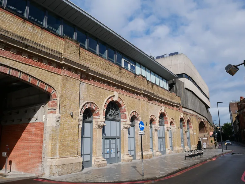 Yellow brick railway viaduct arches on St Thomas Street in Southwark, each arch closed off by a tall grey door