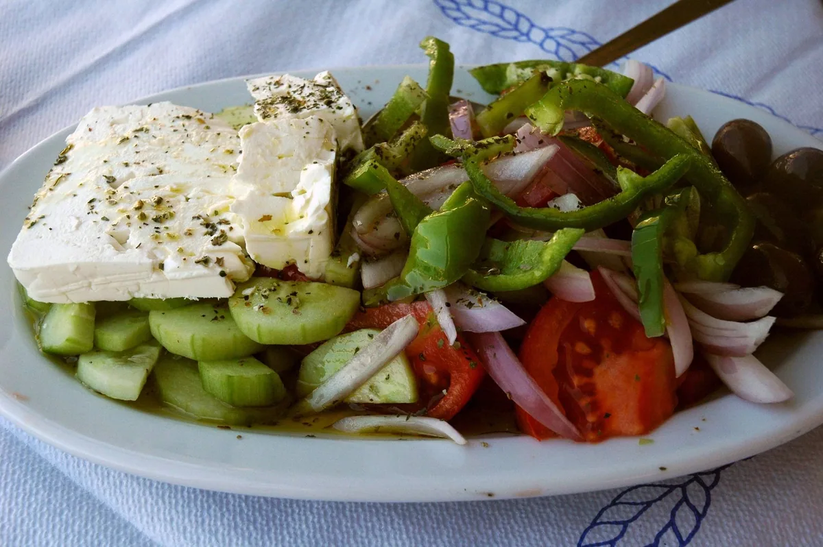 A horiatiki salad of tomato, cucumber, onion and olives topped with a thick slab of feta