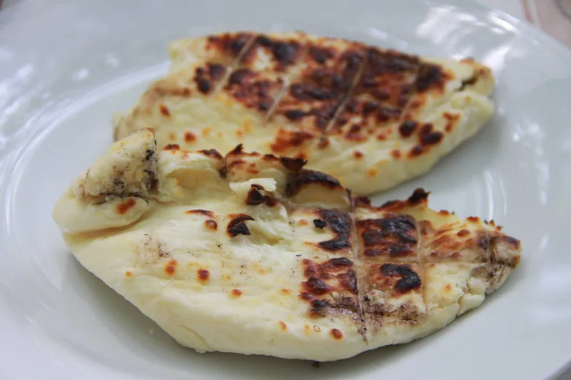 Thick slices of grilled halloumi with dark char marks, served on a plate in Cyprus