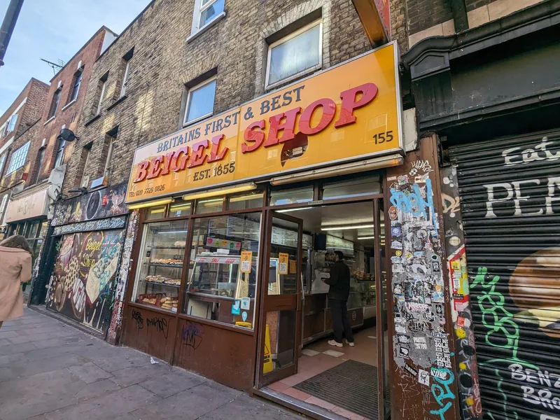 The yellow shopfront of a long-established bagel shop on Brick Lane in east London