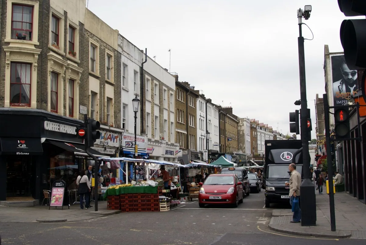 Market stalls and shopfronts along Portobello Road on a grey London afternoon