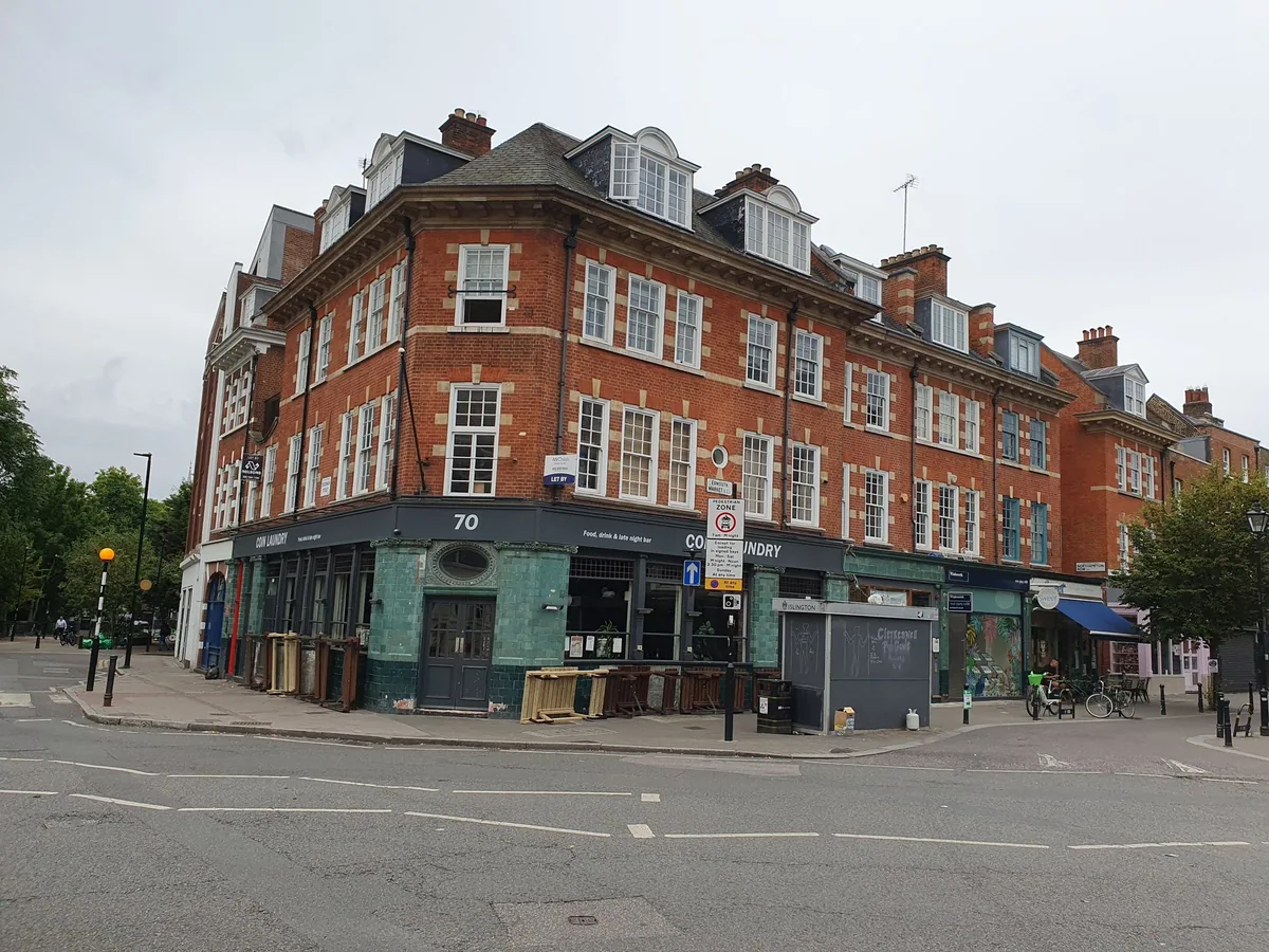 The corner of Exmouth Market in Clerkenwell, a tiled bar front below a red-brick terrace