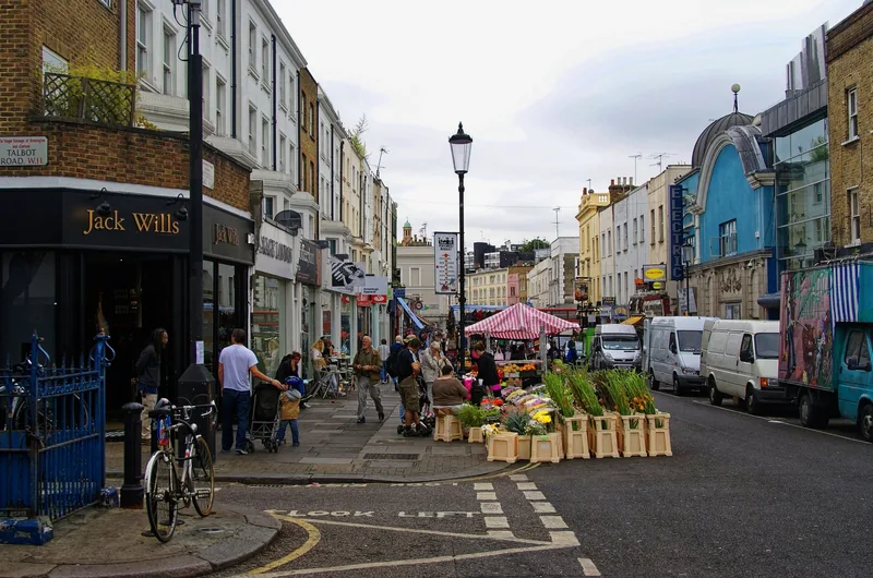 A flower stall and market pitches on Portobello Road near the Electric Cinema