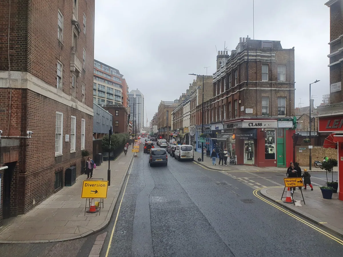 Praed Street near Paddington, lined with small shops and cafes on a grey day