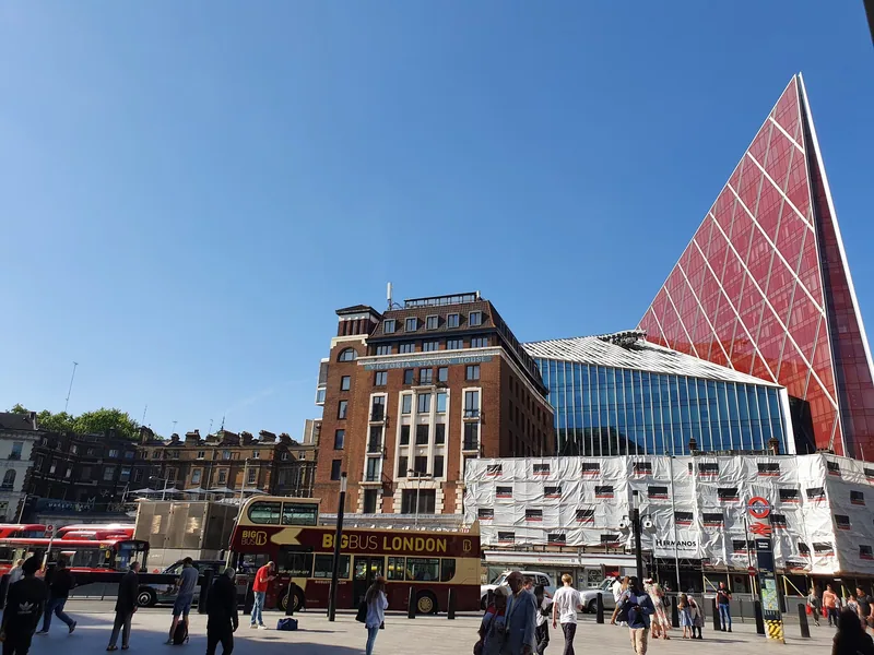 Terminus Place outside Victoria station, with buses on the forecourt and the red glass Nova building behind